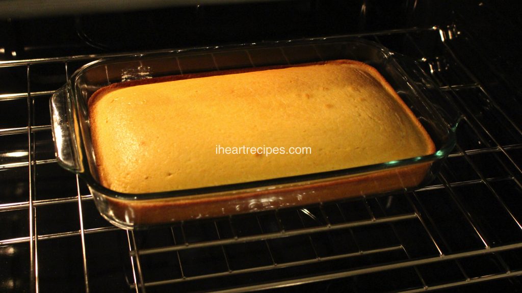 A glass casserole dish of Southern sweet cornbread bakes in the oven.