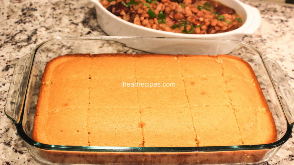 A glass casserole dish filled with cornbread cut into square pieces.