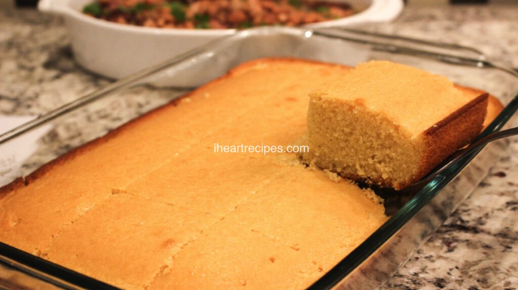A spatula removes a single square of cornbread from a full casserole dish. This sweet Southern cornbread recipe has a moist, tender center and perfectly golden-brown edges.
