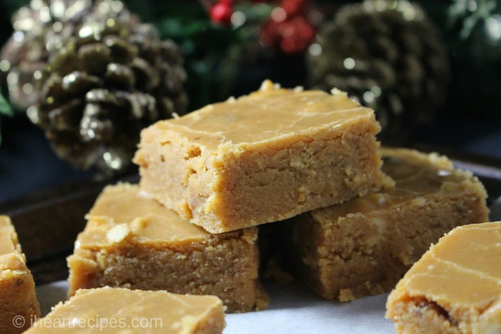 A closeup image of stacked squares of homemade sweet potato pie fudge served as a Thanksgiving dessert.