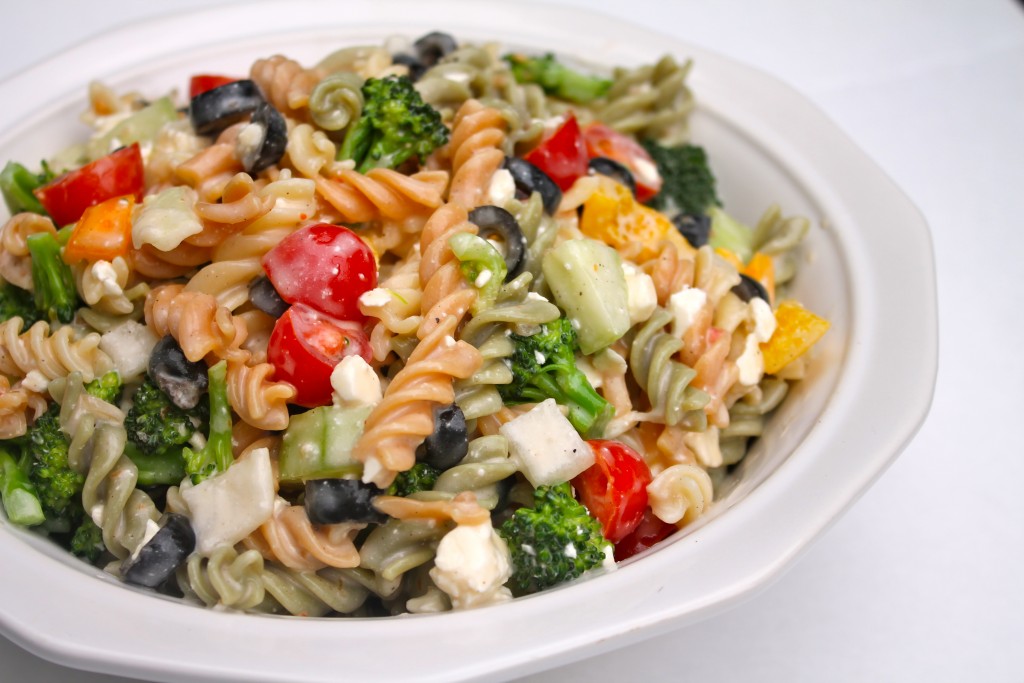 Tender tricolor pasta, bright veggies, and soft cheese tossed in a creamy dressing and served in a round white bowl. This Best Creamy Italian Pasta Salad is a kaleidoscope of colors and flavor!