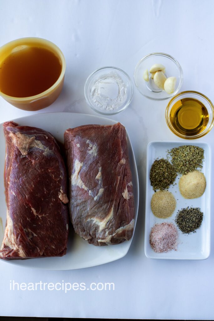 The ingredients for slow cooker tri-tip roast in separate containers on a white table.