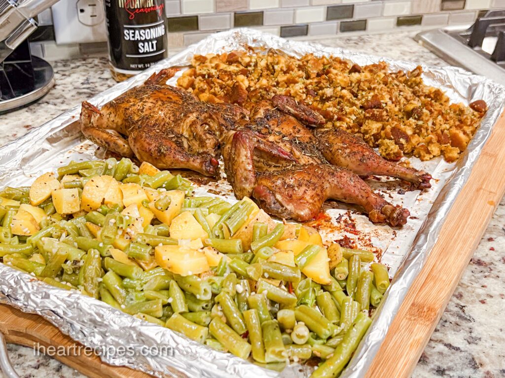A foil-lined sheet pan filled with green beans and potatoes, two Cornish Hens and cornbread stuffing is the perfect Thanksgiving Dinner for Two.