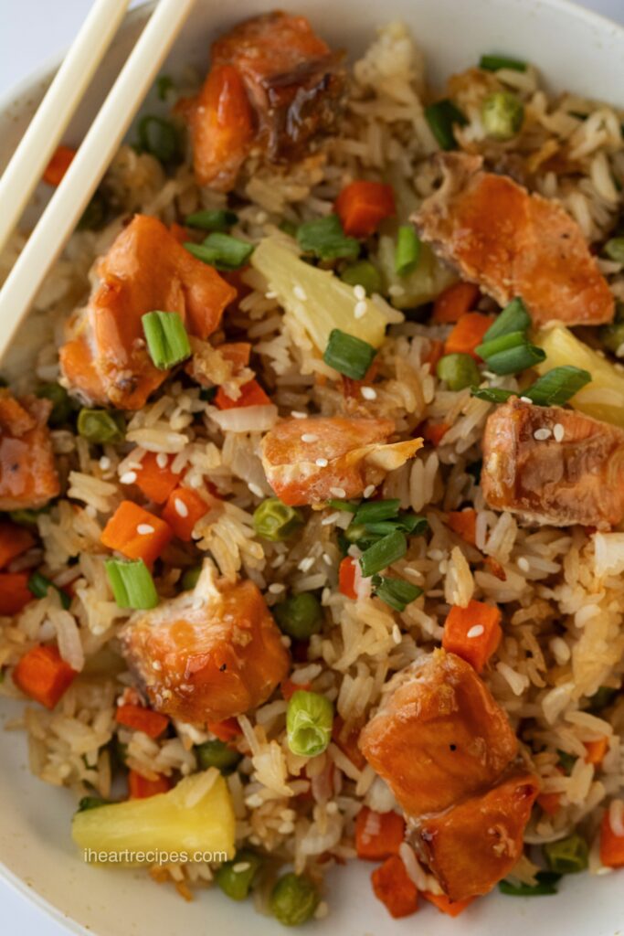 A close-up image of savory salmon, tender rice and bright veggies. 