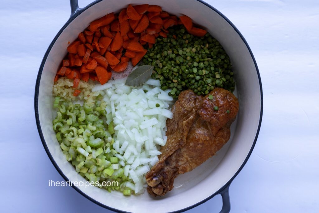 Ingredients for soup neatly separated in a large pot. 
