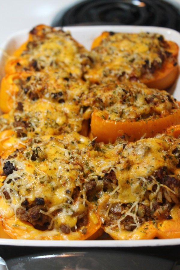 Halved orange and yellow bell peppers filled with tender beef and topped with cheese. Serve these Stuffed Bell Peppers with a side salad for a complete, delicious dinner!
