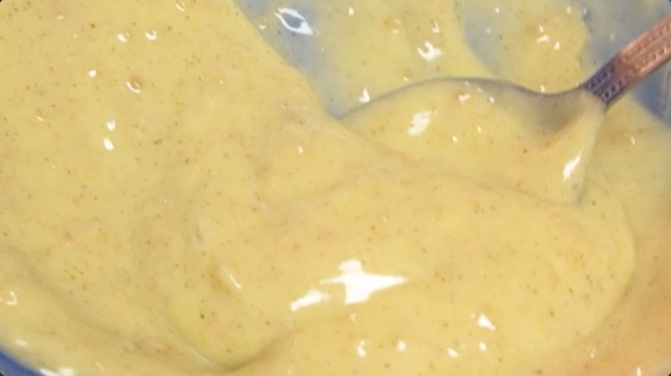 A closeup image of a bowl of herb butter, which will be used to season the easy Thanksgiving turkey.