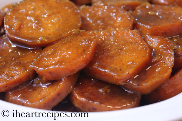A close up image of sliced candied yams in a dish.
